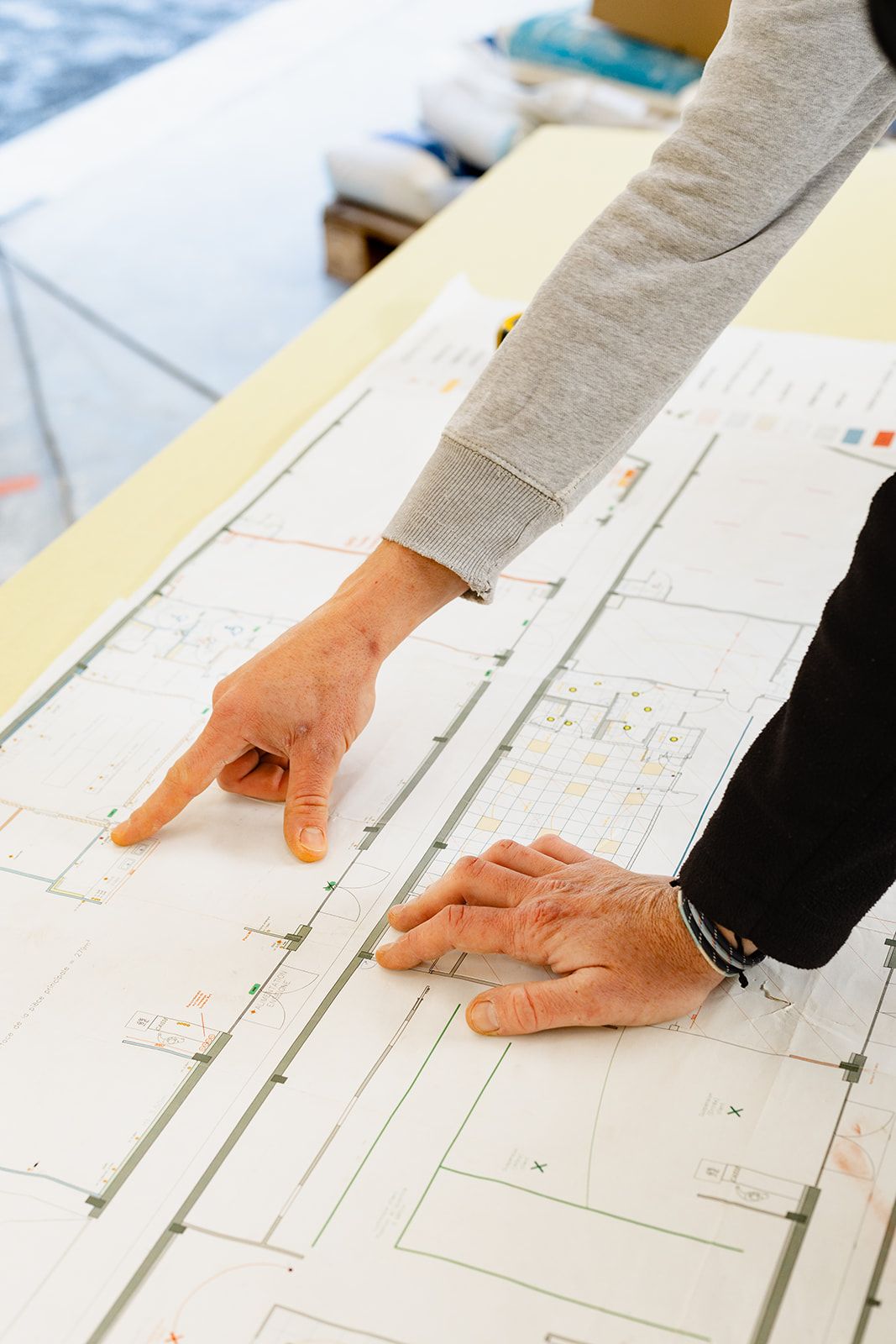 Analyse de plans techniques sur une table.